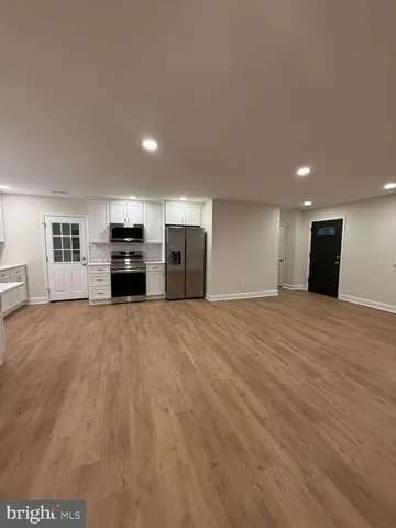 a view of kitchen with refrigerator and window