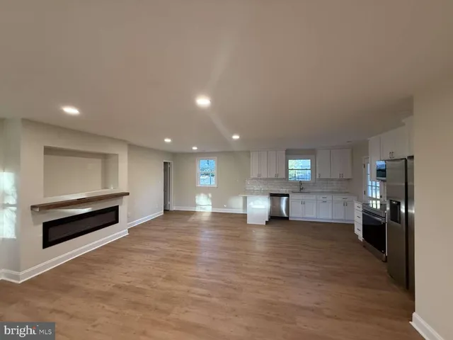 a view of a kitchen with a sink and a refrigerator