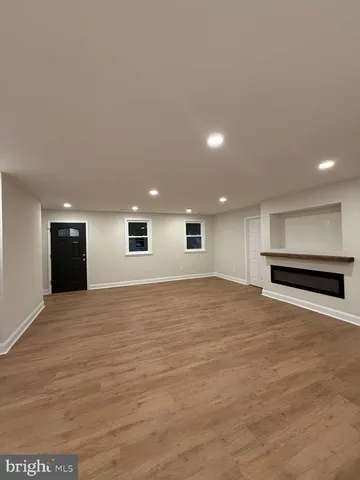 a view of an empty room with a kitchen
