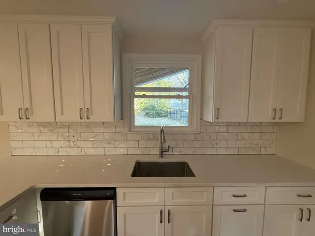 a kitchen with a sink and cabinets