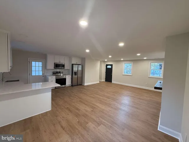 a view of a kitchen with a sink and a refrigerator