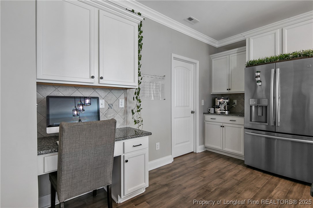 2628 Riddle Farm Road Hope Mills, NC 28348 - Photo 17 of 50 a kitchen with stainless steel appliances granite countertop a refrigerator sink and cabinets