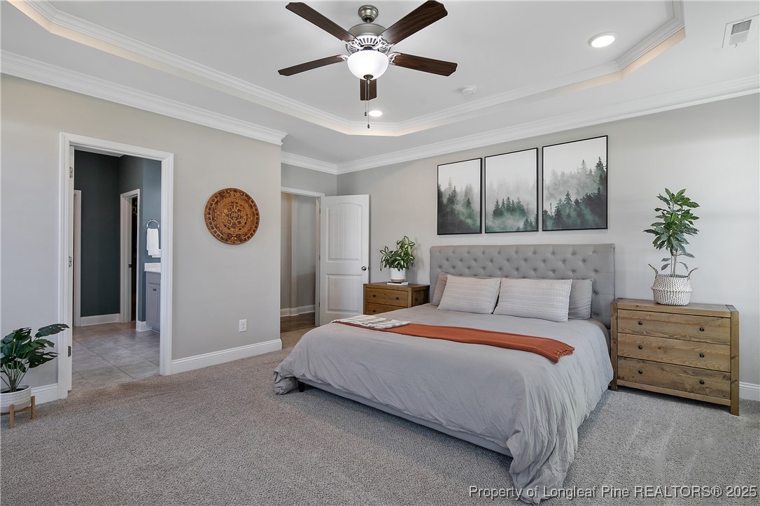 2628 Riddle Farm Road Hope Mills, NC 28348 - Photo 27 of 50 a bedroom with a bed and a chandelier