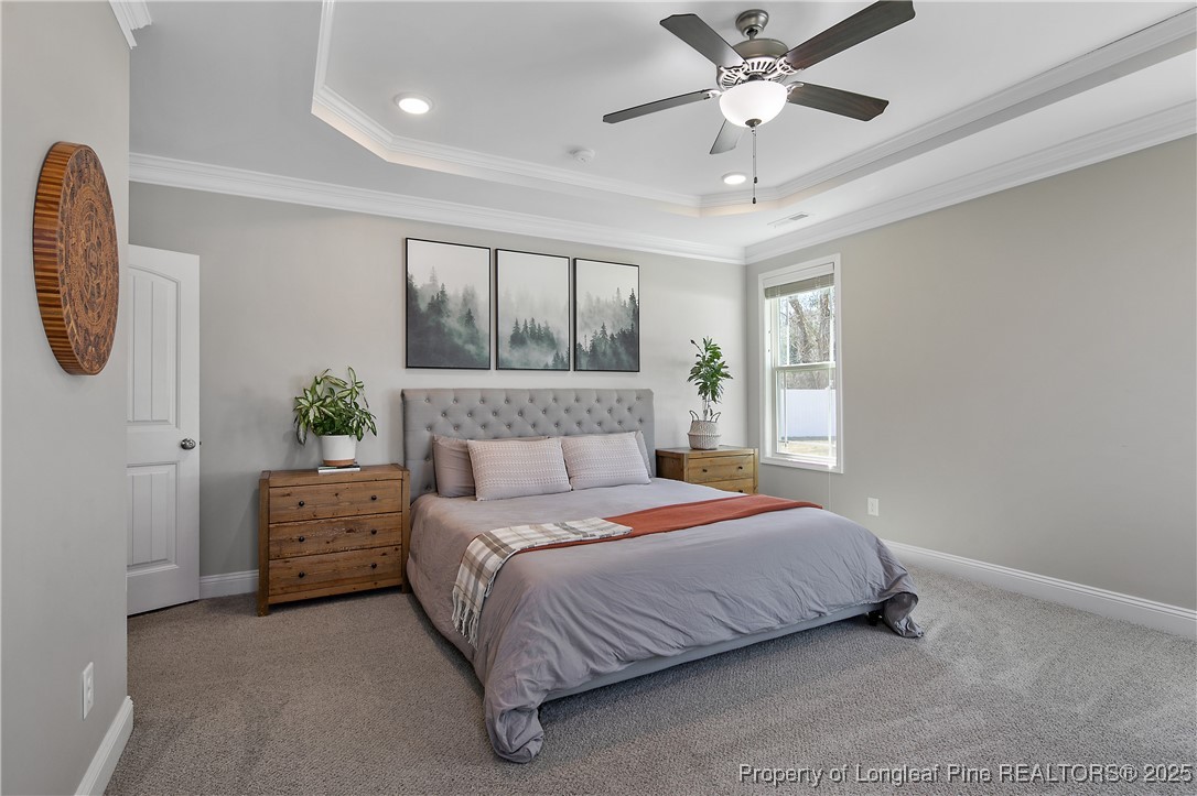 2628 Riddle Farm Road Hope Mills, NC 28348 - Photo 28 of 50 a bedroom with a bed a chandelier and a window