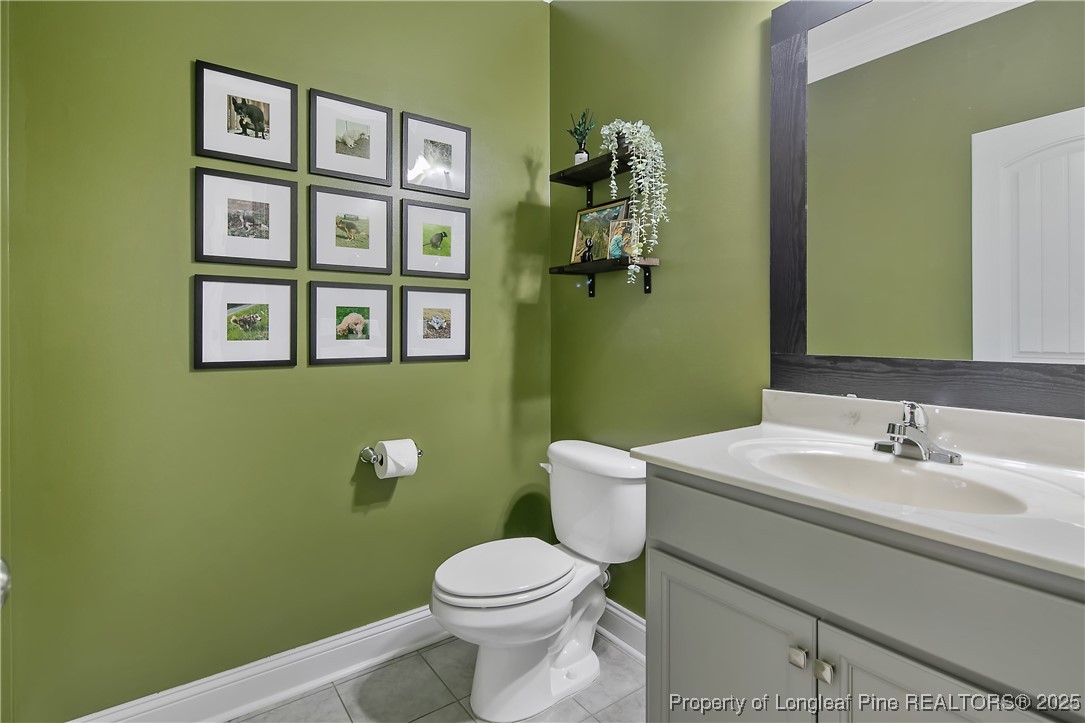 2628 Riddle Farm Road Hope Mills, NC 28348 - Photo 9 of 50 a bathroom with a toilet sink and mirror