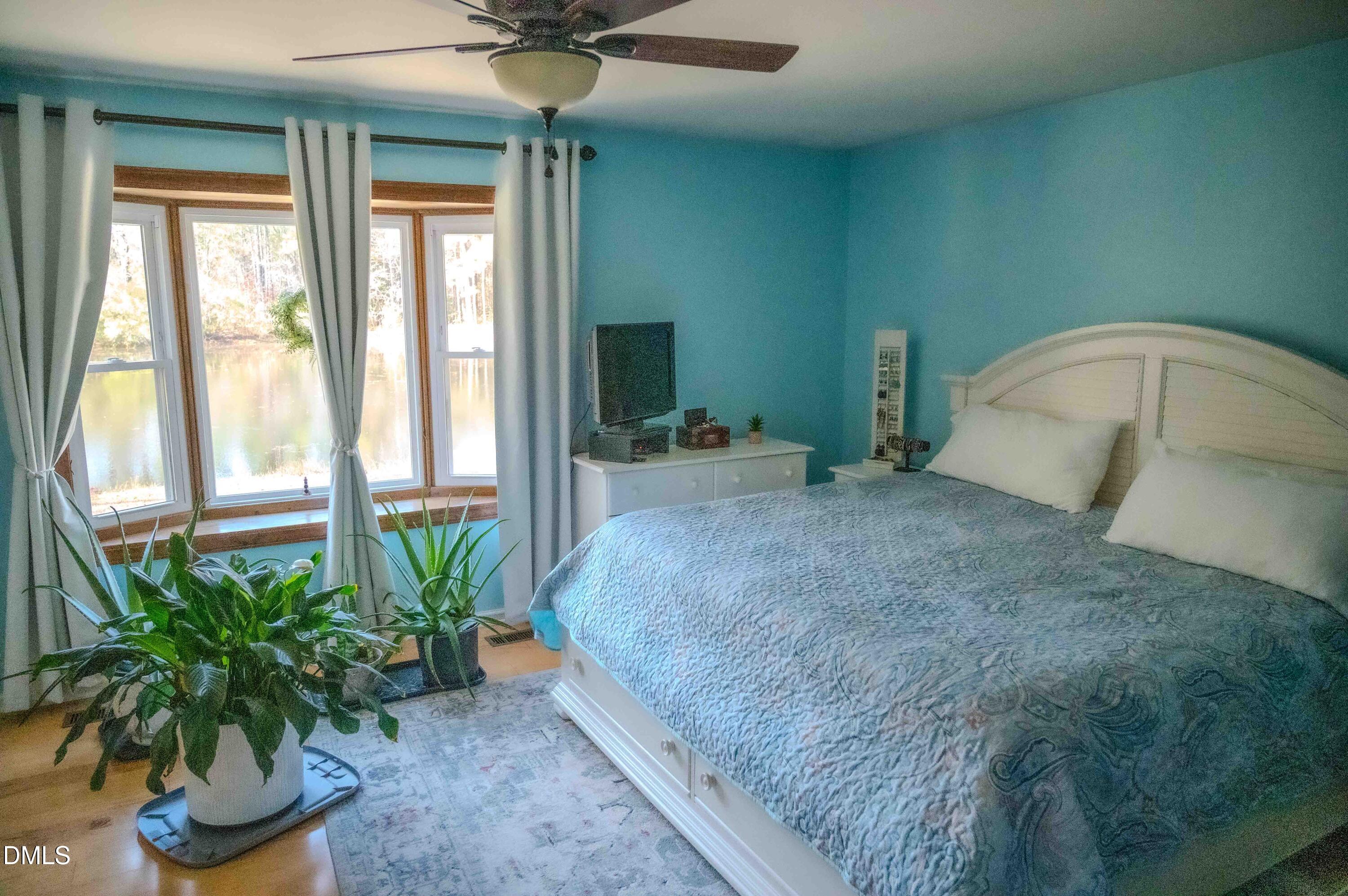 5131 Ponderosa Road Sanford, NC 27332 - Photo 21 of 51 a bedroom with a bed and a potted plant