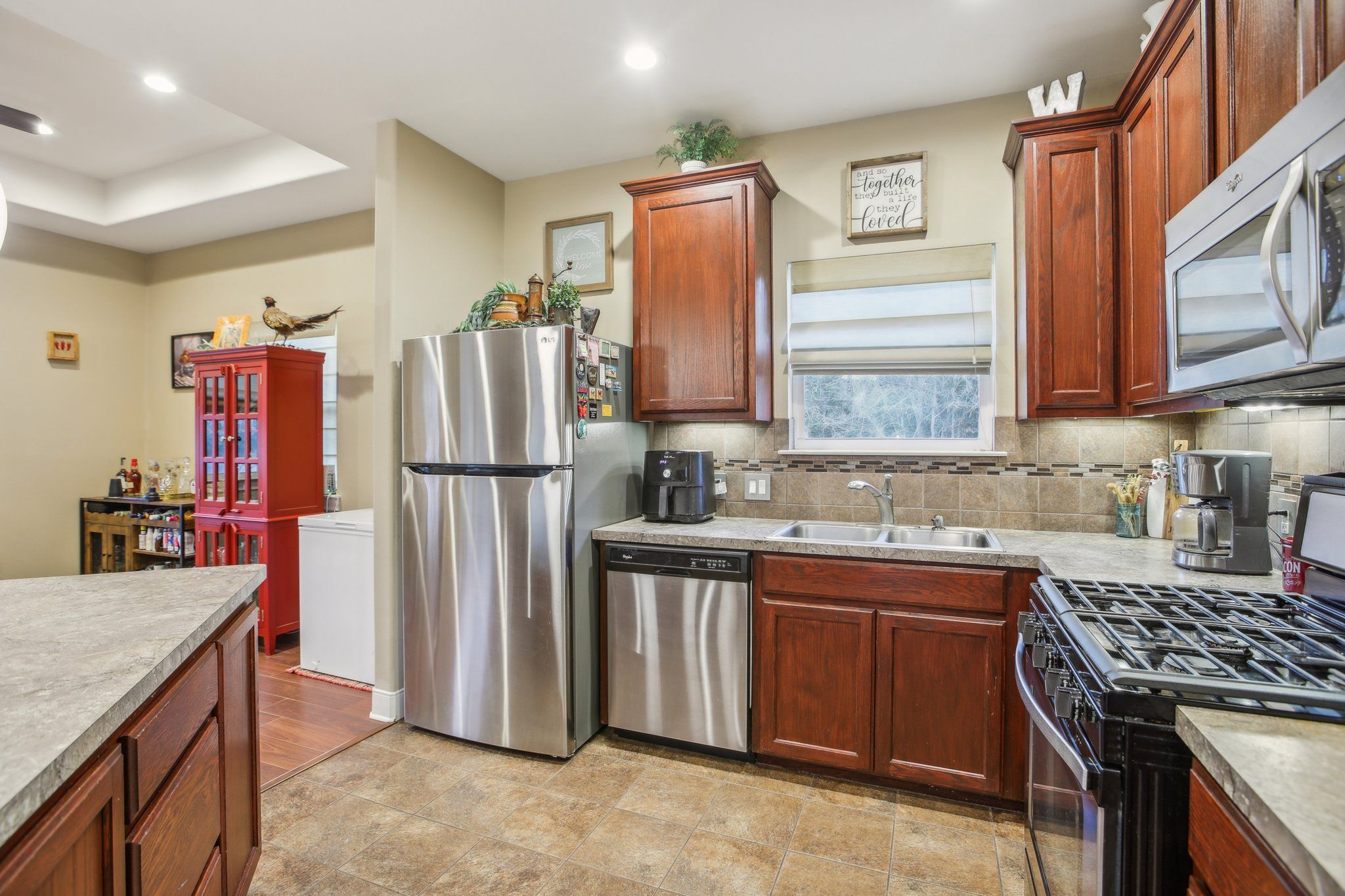 198 Kelley Road East Bastrop, TX 78602 - Photo 16 of 40 a kitchen with stainless steel appliances granite countertop a sink stove and refrigerator