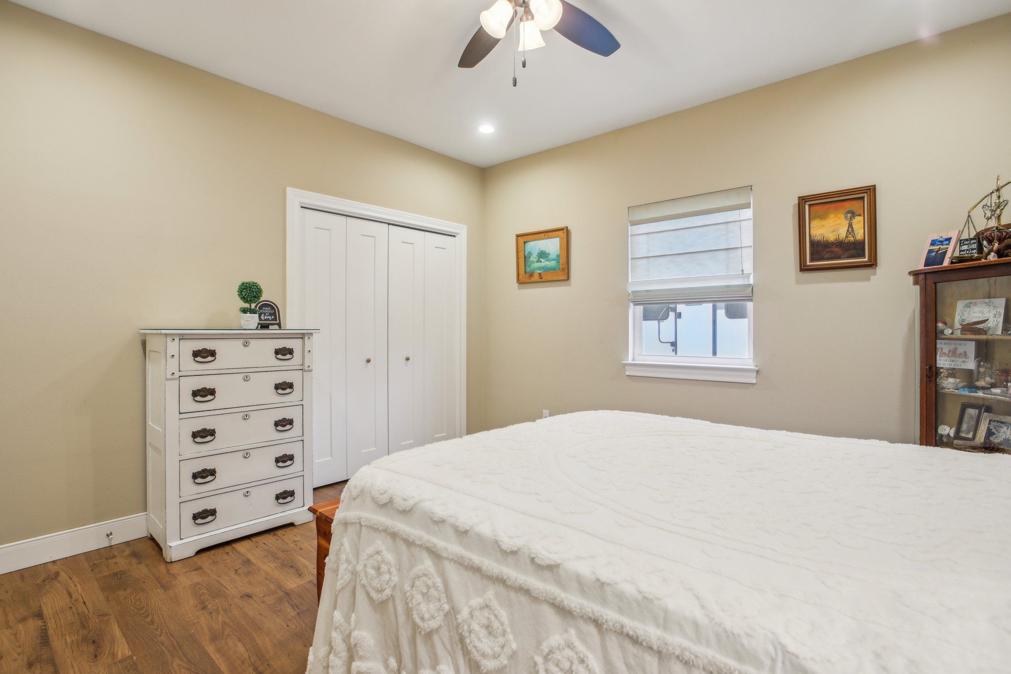 198 Kelley Road East Bastrop, TX 78602 - Photo 22 of 40 a spacious bedroom with a bed and a chandelier