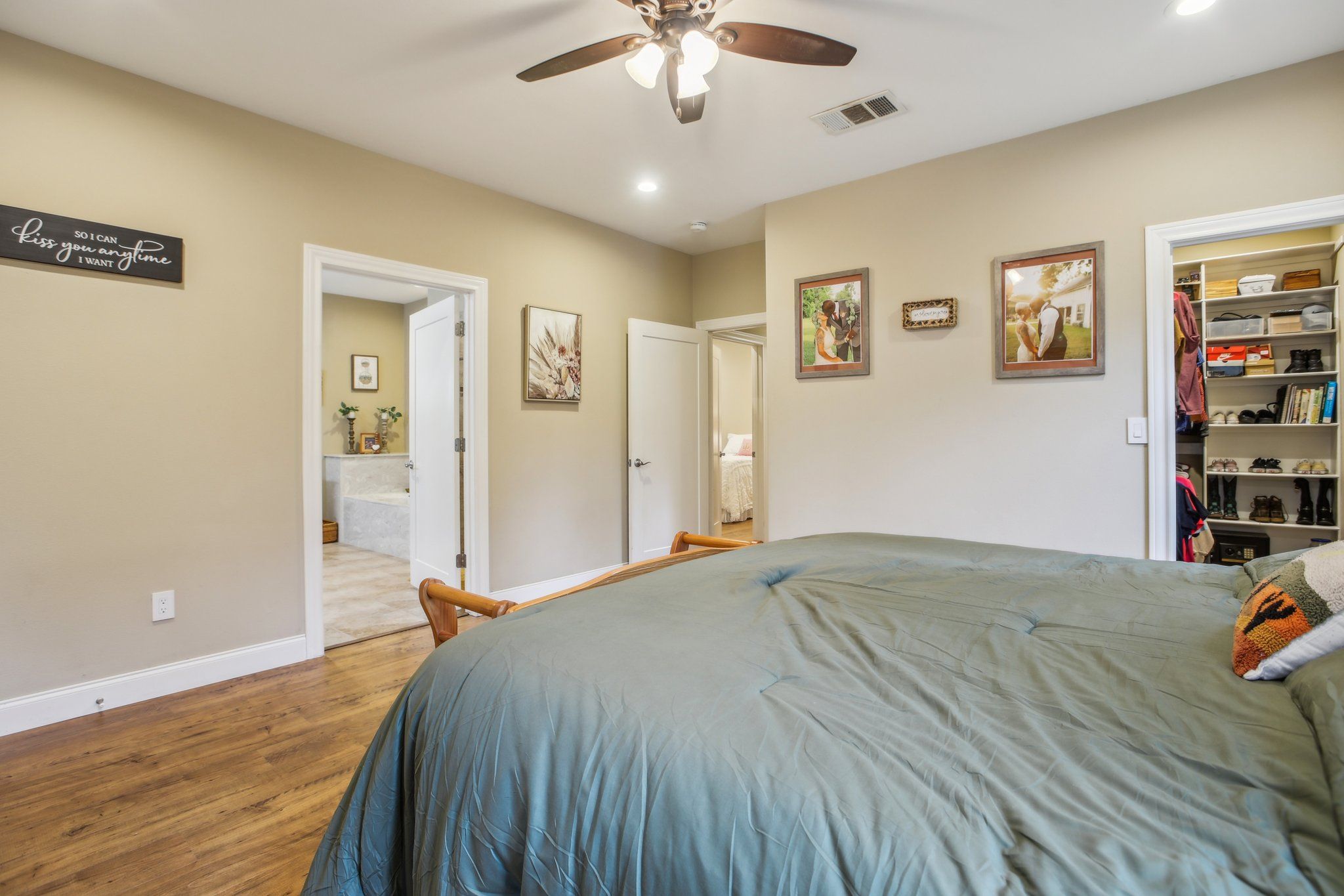 198 Kelley Road East Bastrop, TX 78602 - Photo 25 of 40 a bedroom with a bed and a chandelier