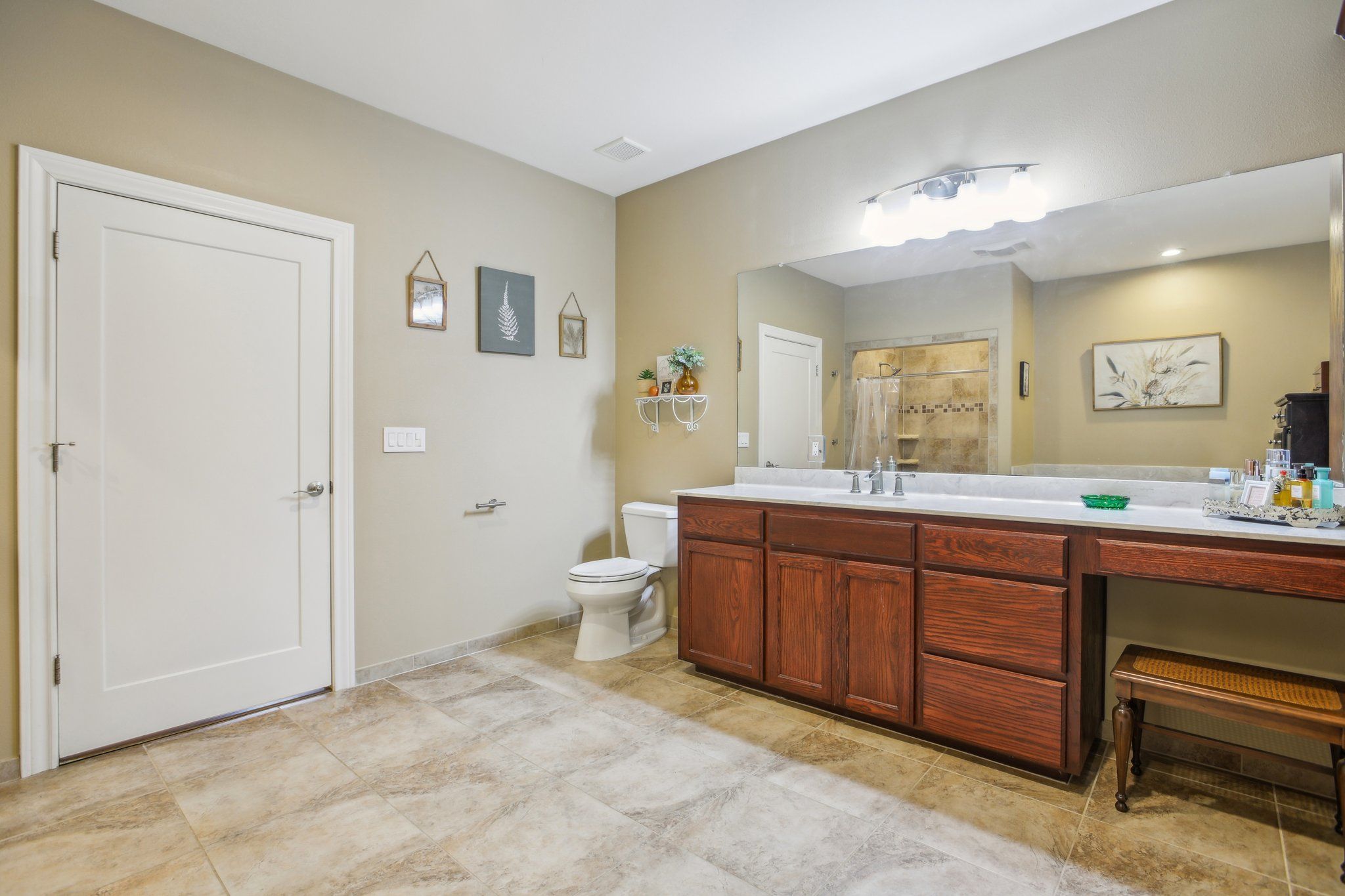 198 Kelley Road East Bastrop, TX 78602 - Photo 28 of 40 a spacious bathroom with a double vanity sink a large mirror and a