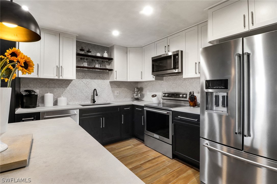2574 Bayshore Drive Matlacha, FL 33993 - Photo 16 of 43 a kitchen with stainless steel appliances a refrigerator sink and microwave