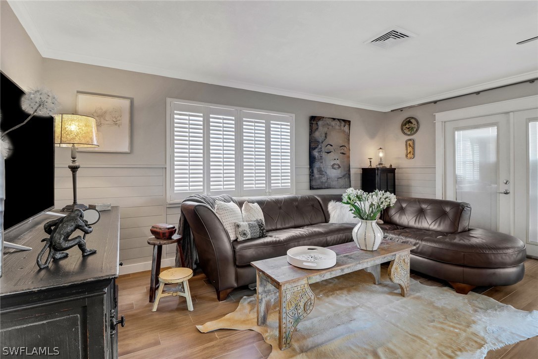 2574 Bayshore Drive Matlacha, FL 33993 - Photo 21 of 43 a living room with furniture a flat screen tv and a window