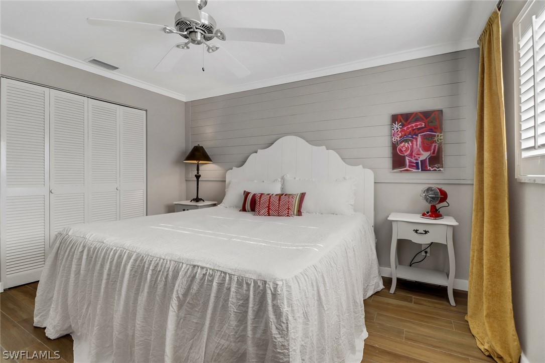 2574 Bayshore Drive Matlacha, FL 33993 - Photo 25 of 43 a bedroom with a bed and a chandelier