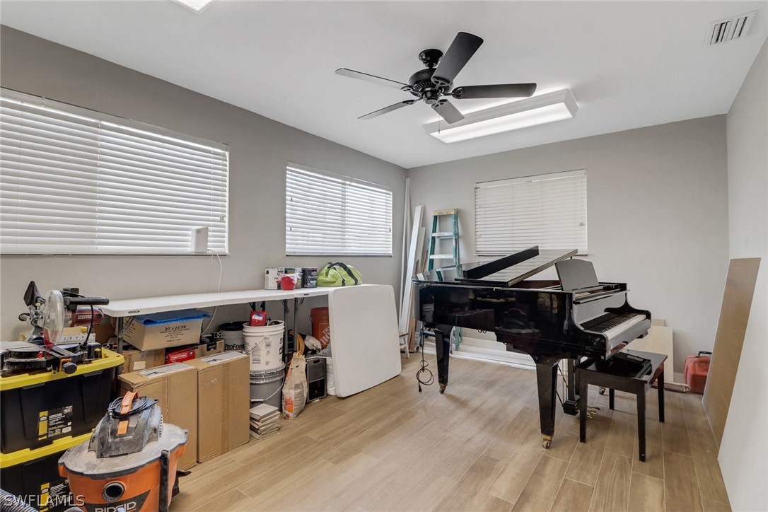 2574 Bayshore Drive Matlacha, FL 33993 - Photo 29 of 43 a work room with furniture and wooden floor
