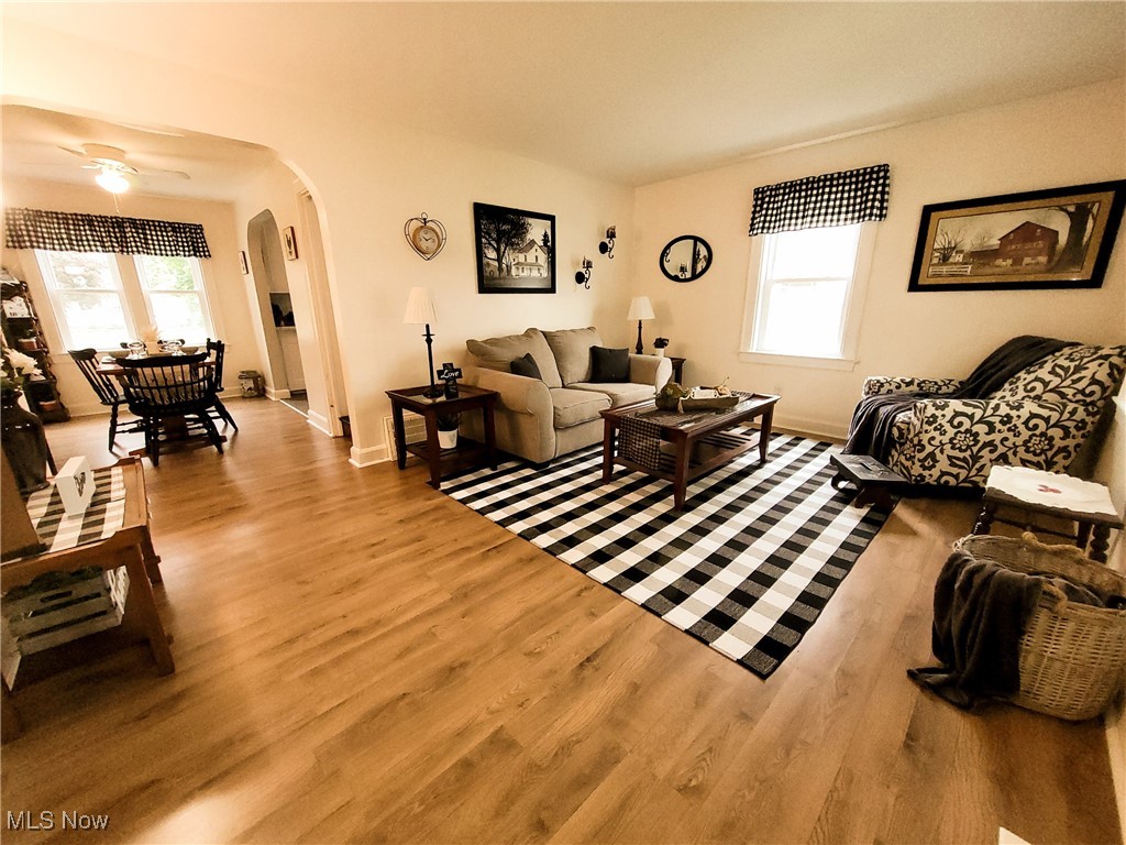 3524 State Road Ashtabula, OH 44004 - Photo 4 of 45 Living room with arched walkways, wood finished floors, baseboards, and ceiling fan