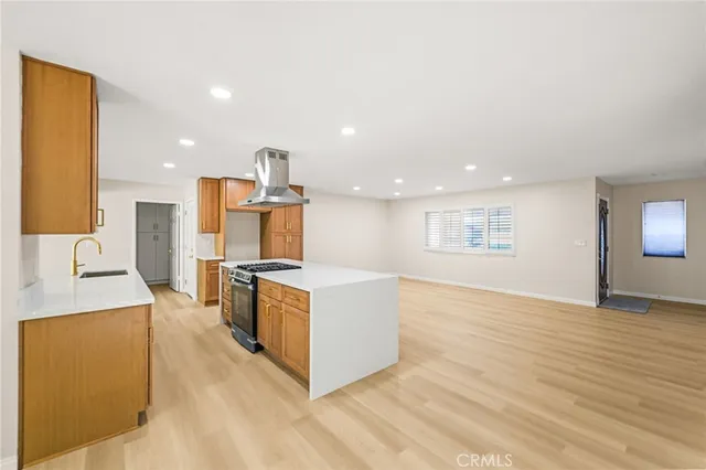 a kitchen with stainless steel appliances granite countertop a sink a stove and a refrigerator