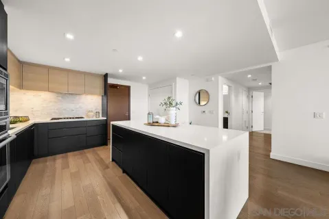 a large kitchen with kitchen island a sink stainless steel appliances and cabinets