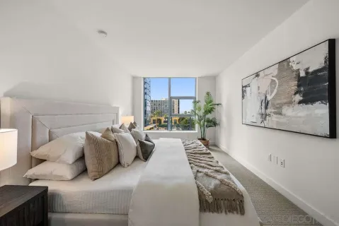 a bedroom with a large bed and a window