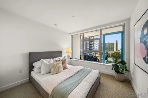 a bed room with a bed and a potted plant