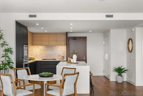 a kitchen with granite countertop a counter space dining table and chairs