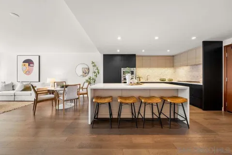 a dining hall with stainless steel appliances a dining table and chairs