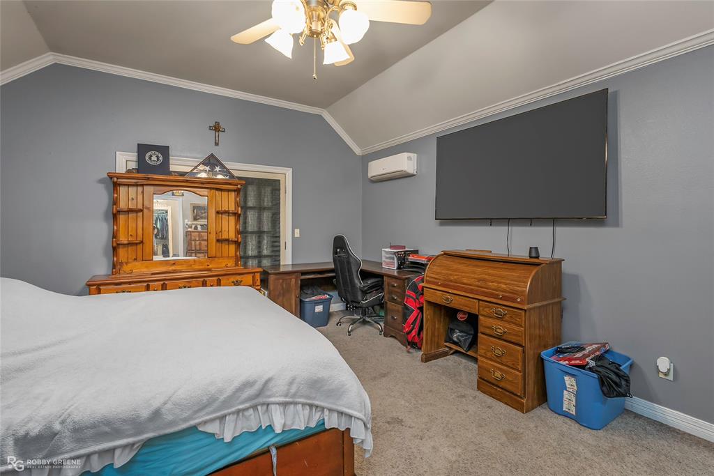 12168 Highway 157 Princeton, LA 71067 - Photo 29 of 32 Bedroom with crown molding, vaulted ceiling, light carpet, a ceiling fan, and a desk