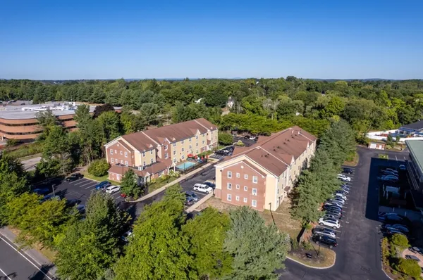 an aerial view of a house with a yard