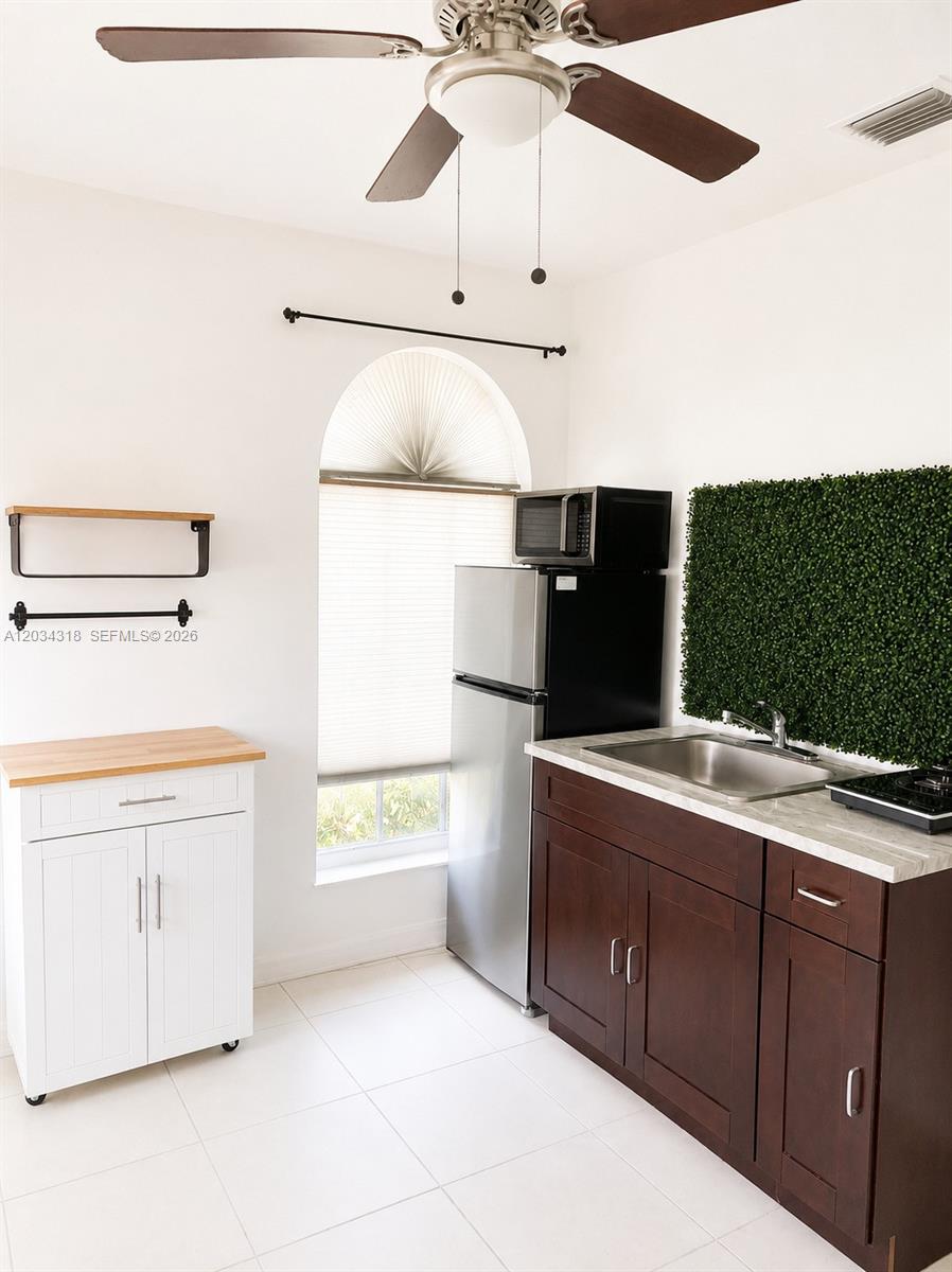 14856 Southwest 179th Street Miami, FL 33187 - Photo 10 of 33 a kitchen with a sink cabinets and appliances