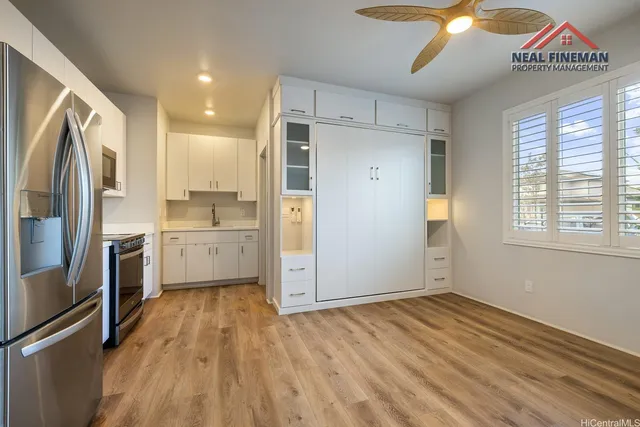 a kitchen with a refrigerator a sink and cabinets