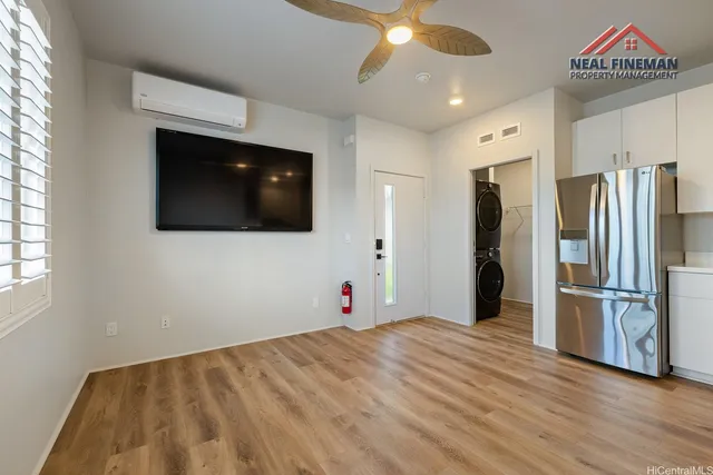 a view of a kitchen with a flat screen tv and refrigerator