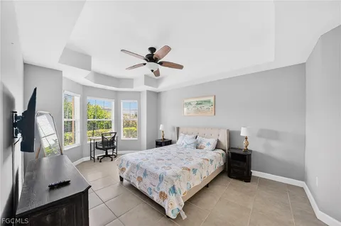 a bedroom with a large bed and a large window