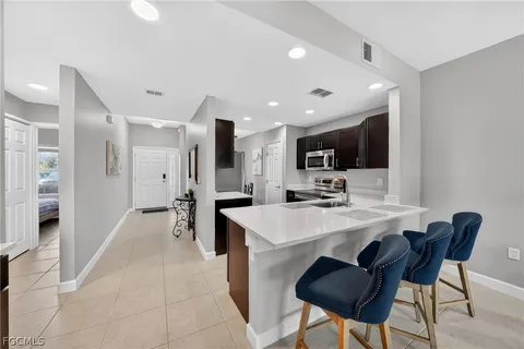 a kitchen with stainless steel appliances kitchen island granite countertop a sink and cabinets