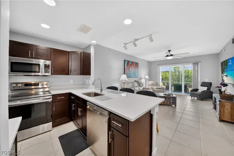 a kitchen with sink cabinets and stainless steel appliances