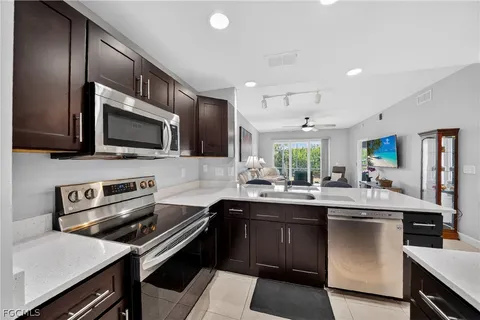 a kitchen with stainless steel appliances a sink stove and microwave