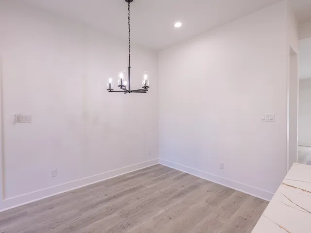 a view of an empty room with a chandelier