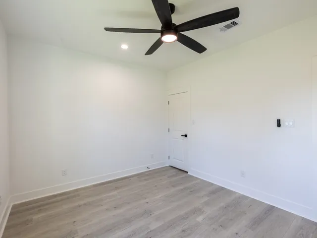 a view of a room with wooden floor