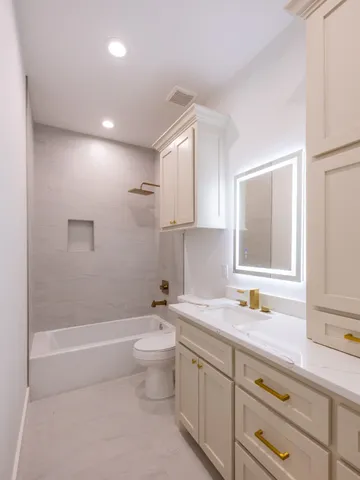 a bathroom with a sink a toilet and a bathtub
