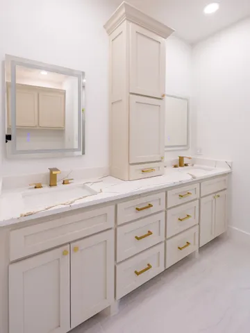 a bathroom with a double vanity sink and mirror
