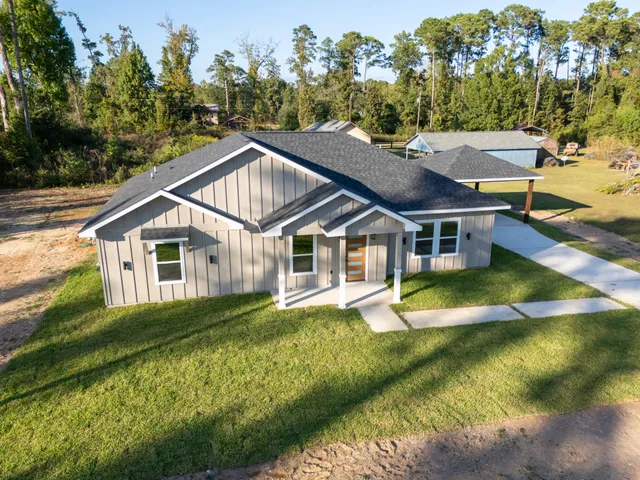 a aerial view of a house with swimming pool next to a yard
