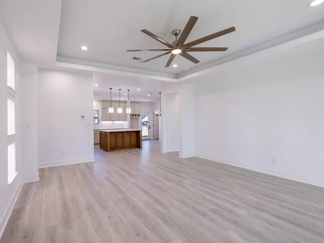 a view of a livingroom with a hardwood floor and a ceiling fan