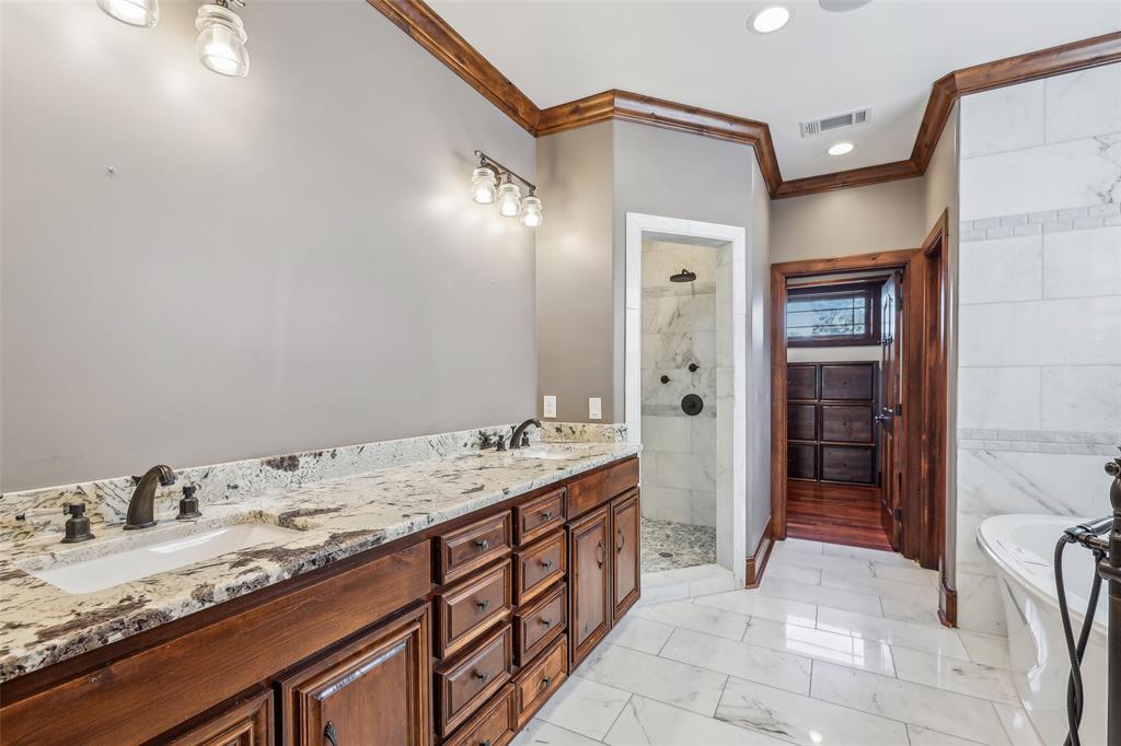 1904 East 13th Street, Unit A Austin, TX 78702 - Photo 14 of 27 Bathroom featuring ornamental molding, a freestanding bath, a tile shower, double vanity, and recessed lighting