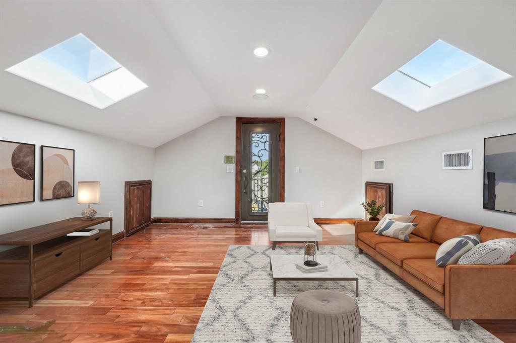 1904 East 13th Street, Unit A Austin, TX 78702 - Photo 20 of 27 Living room with a skylight, lofted ceiling, and light wood finished floors