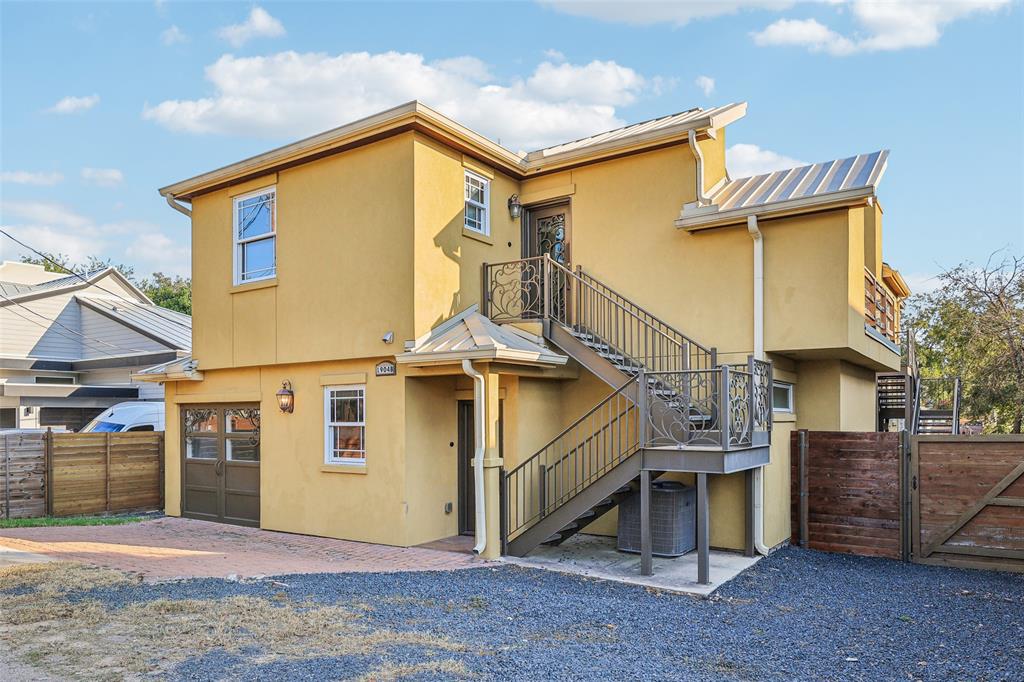 1904 East 13th Street, Unit A Austin, TX 78702 - Photo 26 of 27 Back of property with stairs, stucco siding, and a gate