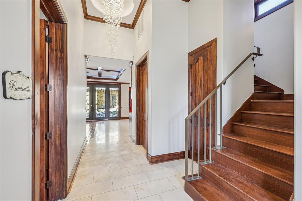 1904 East 13th Street, Unit A Austin, TX 78702 - Photo 3 of 27 Hall with light tile patterned flooring, a high ceiling, stairway, french doors, and crown molding