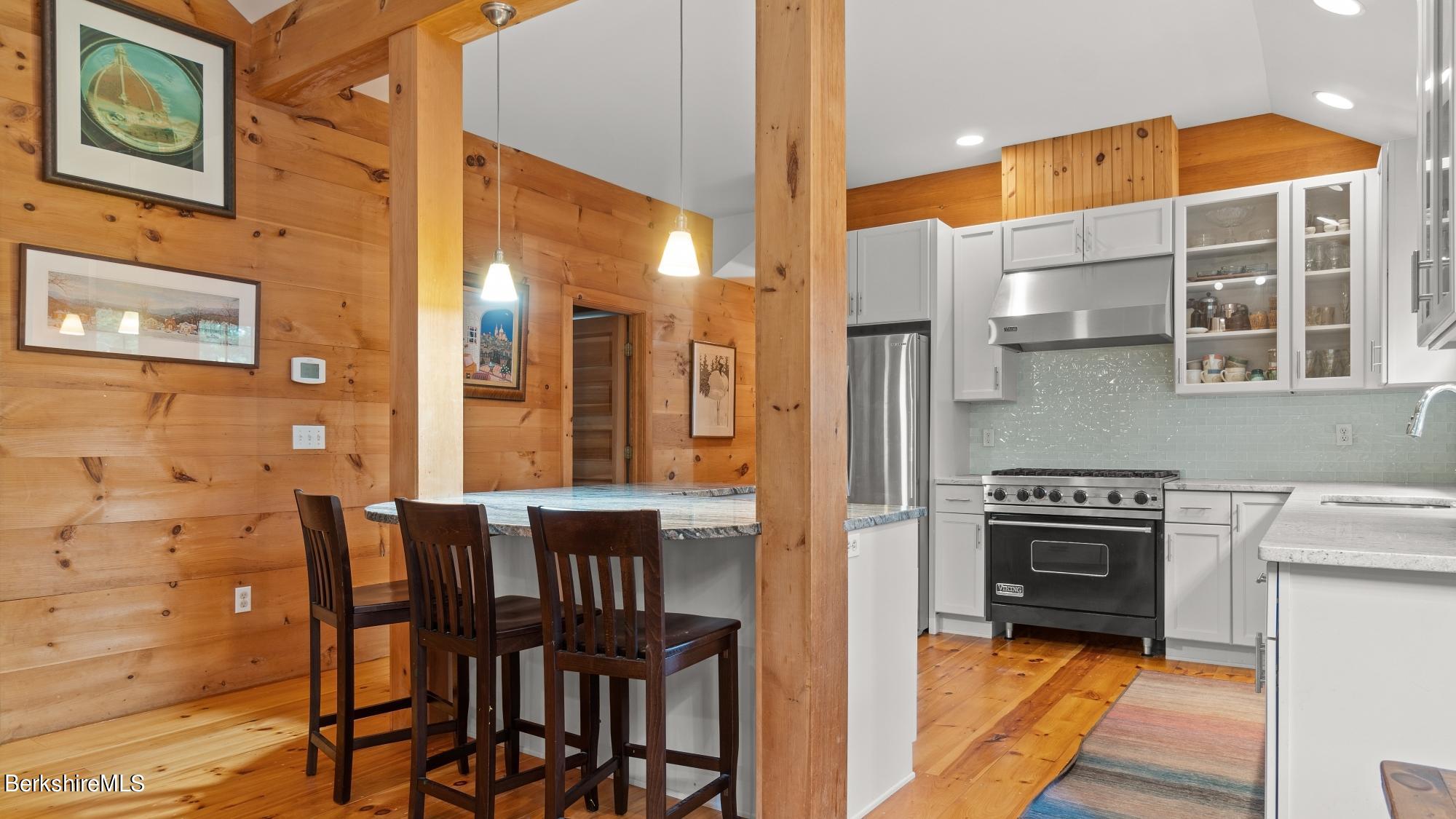 30 Lake Mansfield Road Great Barrington, MA 01230 - Photo 12 of 35 a kitchen with a table chairs and a stove