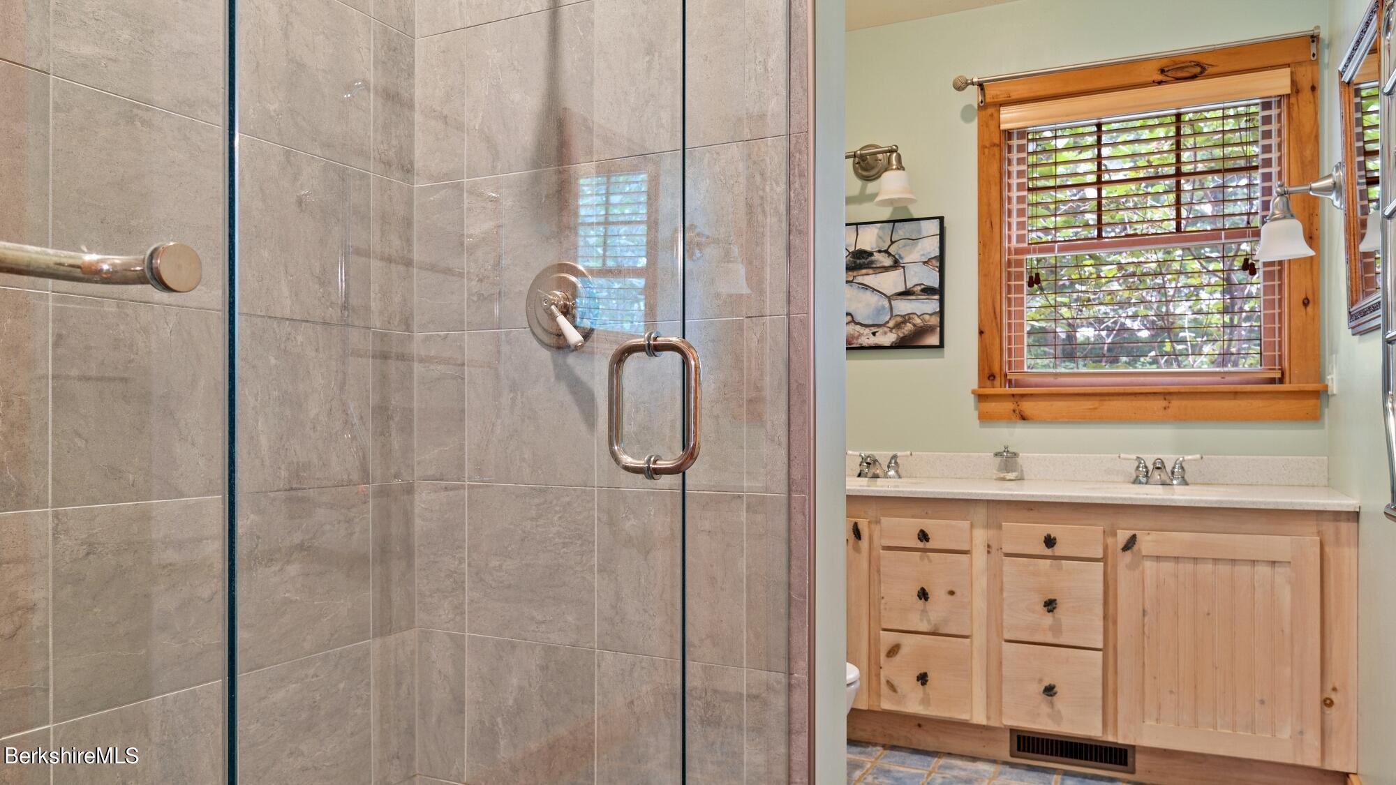 30 Lake Mansfield Road Great Barrington, MA 01230 - Photo 21 of 35 a bathroom with a granite countertop sink a shower and a window