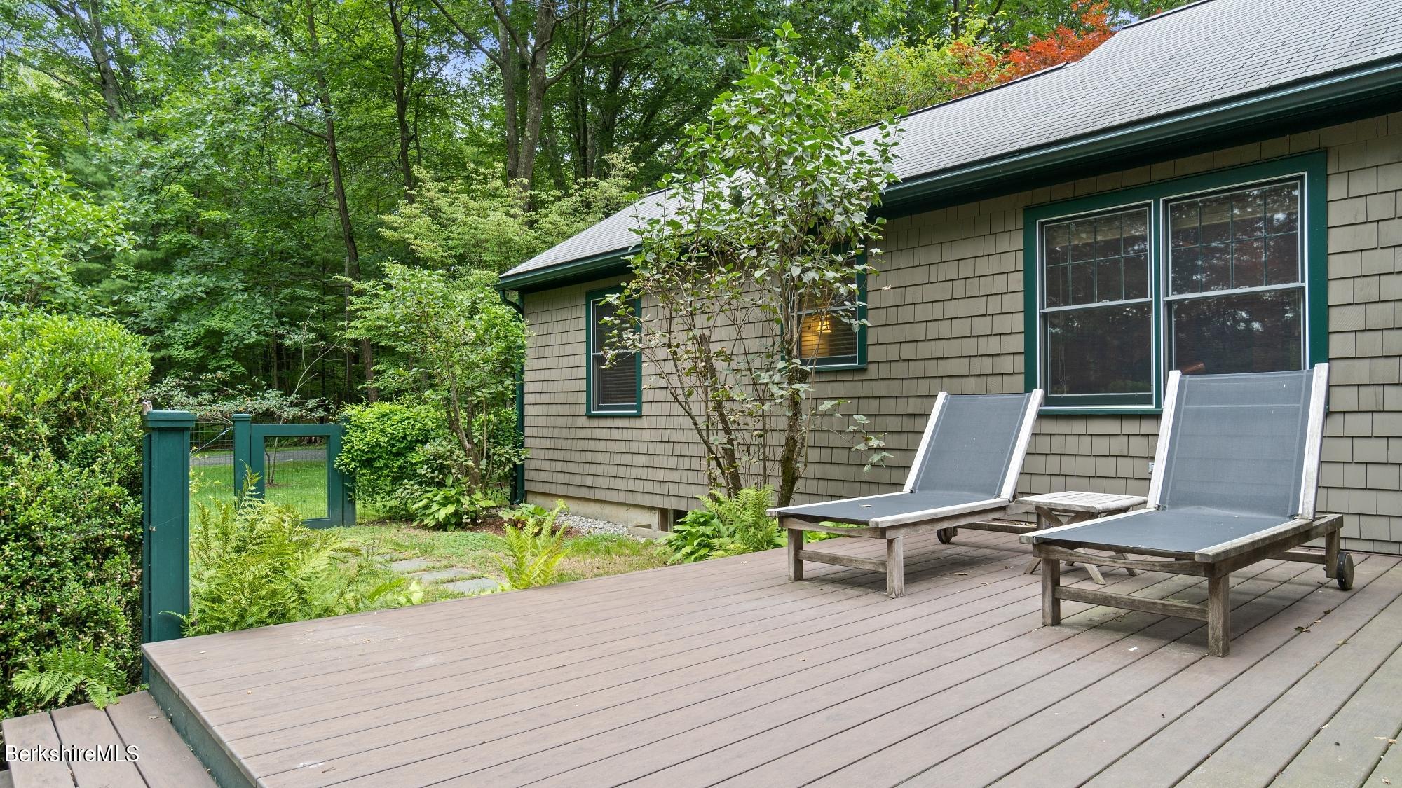 30 Lake Mansfield Road Great Barrington, MA 01230 - Photo 31 of 35 a house with a bench in the patio