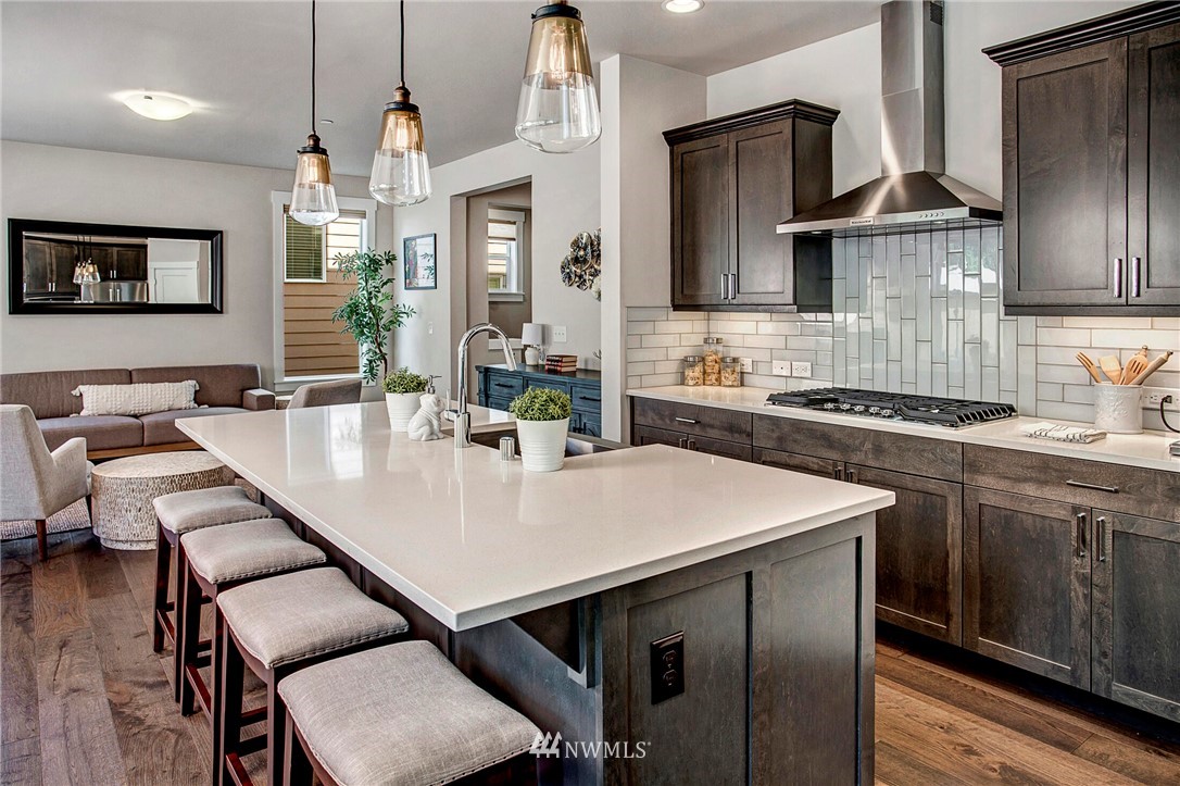 22326 9th Drive Southeast Bothell, WA 98021 - Photo 11 of 40 a kitchen with stainless steel appliances granite countertop a sink a stove and chairs