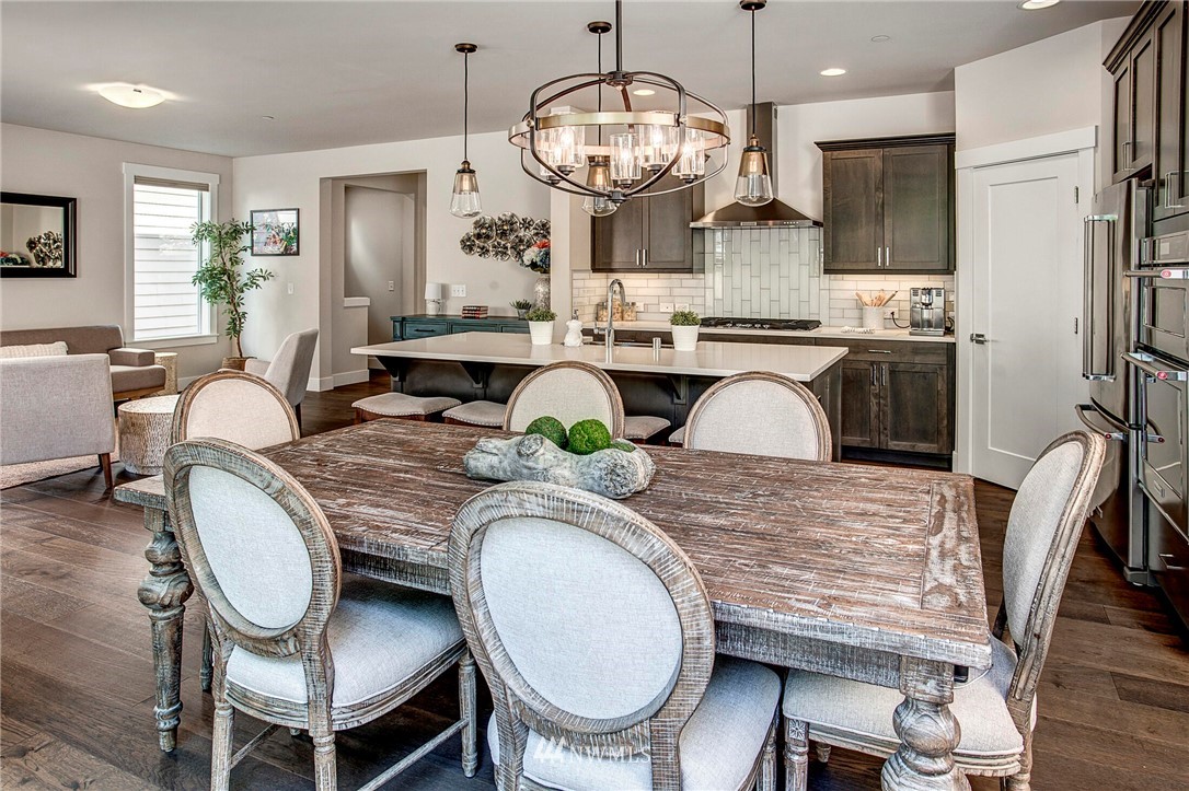22326 9th Drive Southeast Bothell, WA 98021 - Photo 13 of 40 a very nice looking dining room with kitchen island stainless steel appliances furniture a large window and kitchen view