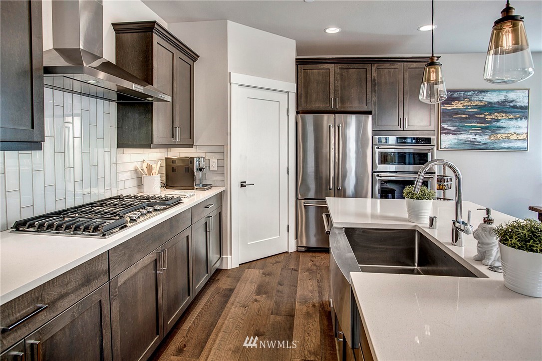 22326 9th Drive Southeast Bothell, WA 98021 - Photo 14 of 40 a kitchen with stainless steel appliances a stove a sink and a refrigerator
